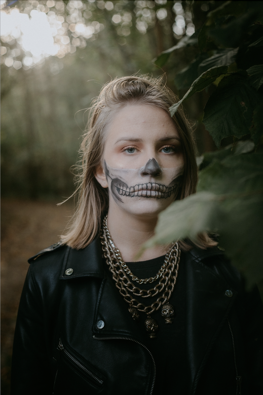 A girl with face painted. Unmasking Hidden Dangers: Safer Halloween Makeup & Skincare